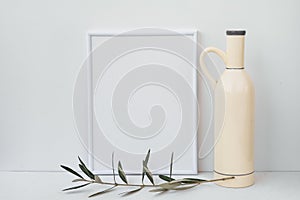 Frame mockup on white background, ceramic bottle, olive tree branch, clean minimalist styled image