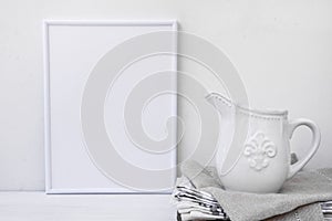 Frame mockup, white vintage pitcher on stack of linen towels, minimalist clean styled image