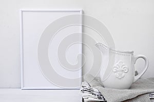 Frame mockup, white vintage pitcher on stack of linen towels, minimalist clean styled image photo