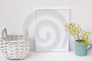 Frame mockup, wicker basket, pitcher with flowers on white background, styled image for product marketing