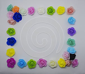 Multicolored artificial roses on a white background
