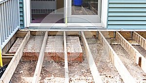 Frame of a new deck being constructed on back of house