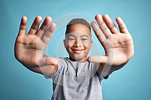 .Frame, photographer and hands portrait of child with satisfied smile for creative expression. Inspiration, perspective