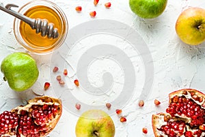 Frame of pomegranate, pomegranate seeds and apples with honey for the Rosh Hashanah