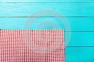 Frame of red plaid texture on blue wooden kitchen. Top view and copy space. Mock up