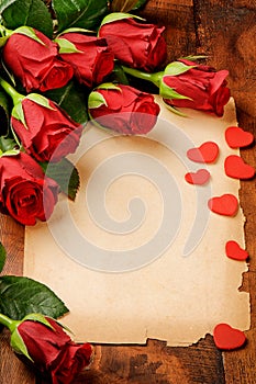 Frame with red roses and vintage paper