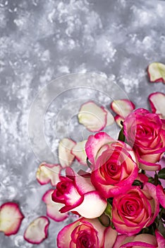 Frame of Red white rose flower bouquet on stone table.