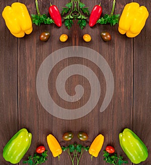 Frame shape, flat lay with colorful vegetables and copy space. Fresh bell peppers, cherry tomatoes and parsley