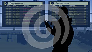 The frame shows an airport with a waiting room. A woman in silhouette looks at the scoreboard and checks the flights