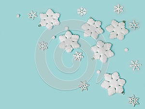 Frame of snowflakes on light blue background, pastel colors Christmas holiday composition top view, copy space, flat lay