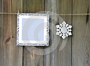 Frame and snowflakes on old wooden background.