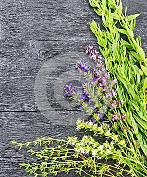 Frame of spicy herbs on black wooden table