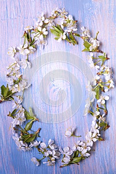 Frame of Spring Flowers on the background of old vintage blue board