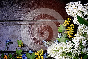 Frame of spring flowers on a wooden background retro vintage style flat lay, overhead view