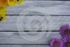 Frame of summer flowers on a light wooden surface 1