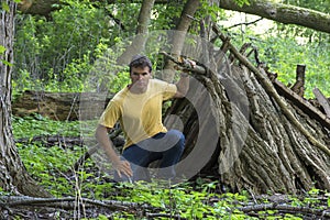 A-frame survival shelter in wooded forest