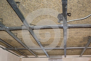 frame of suspended ceiling, wiring and fiberboard photo