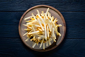 Frame Tempting french fries elegantly presented on a wooden plate