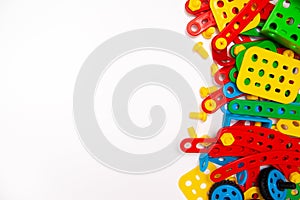 Frame for text. Top view of multicolor kids toy construction blocks bricks on white background. Copyspase. flat lay. Children toys