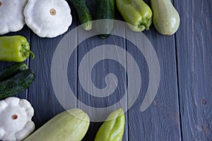 Frame for text with vegetables. Background with cucumbers, Bell peppers, bush pumpkin and a place for inscription. Useful green photo