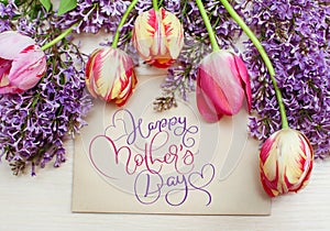 Frame from tulips and lilac and text Happy mothers day. Calligraphy lettering hand draw