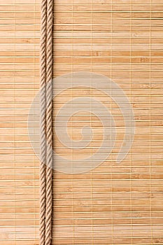 Frame of two smooth ropes lying on a bamboo mat