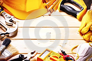 Frame with various tools on wooden background. Construction conc