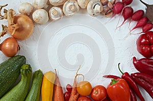 Frame of various vegetarian ingredients ready for cooking on the white table. Organic healthy food: colorful vegetables
