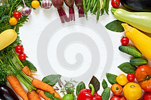 Frame of various vegetarian ingredients ready for cooking on the white table. Organic healthy food: colorful vegetables, herbs