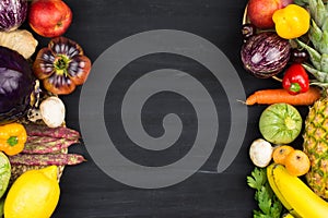 FRAME OF VEGETABLES AND FRUITS ON BLACK BACKGROUND