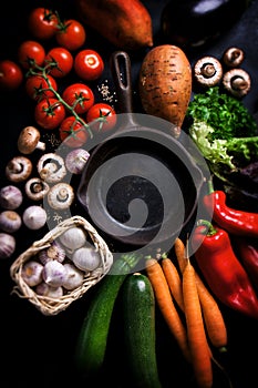 Frame of vegetables with old skillet, healthy or vegetarian concept