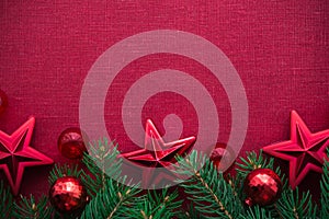 Frame with xmas tree and ornaments on red canvas background. Merry christmas card.
