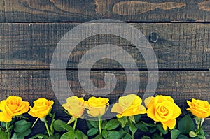 Frame of yellow roses on rustic wooden background. Valentine's D