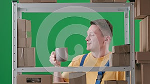 Framed on green background, chromakey. Depicted is a man in uniform. Depicts a storekeeper in a warehouse. He takes a