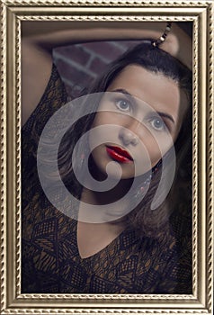 Framed portrait of lovely brunette girl with red lips and hypnotic look of big green eyes