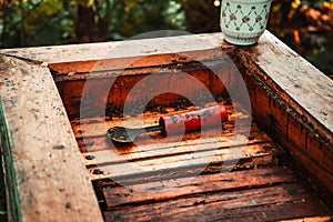 Frames with honey in a wooden beehive in an apiary 4