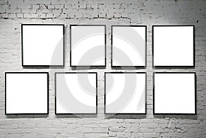 Frames on white brick wall