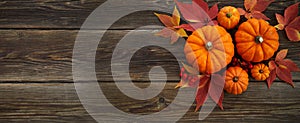 Framework with pumpkins and fall leaves on wooden background. Top view.