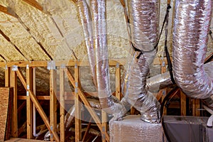 Framework showing the copper plumbing tubing and HVAC vents being installed.