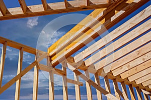 A framing beam supports the layout of the joists in a newly built wooden home.