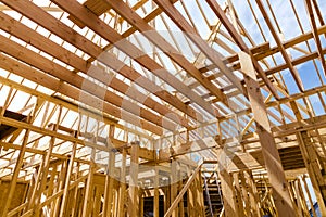 Framing beams of new home under construction wooden roof trusses