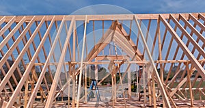 Framing beams on new home under construction wooden roof trusses