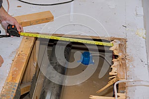 Framing contractor measuring for stubbed up domestic to install plywood subfloor