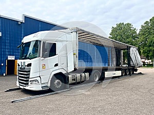 France - 06.23.2023: An open semi-trailer curtain krone on both sides for loading goods into a daf xf truck