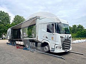 France - 06.23.2023: An open semi-trailer curtain krone on both sides for loading goods into a daf xf truck