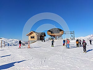 France Alpes Savoie Maurienne Valloire skiers Chairlift sunny blue sky