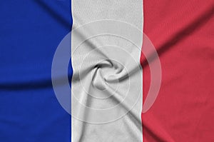 France flag is depicted on a sports cloth fabric with many folds. Sport team banner
