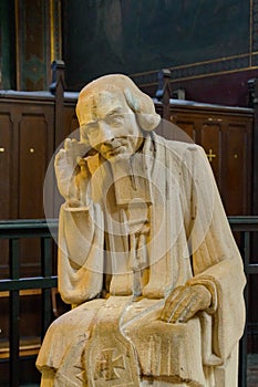 France, Paris, September 26, 2014: Sculpture of St. Jean-Marie Vianney, French Parish Priest, circa 1986 in catholic cathedral