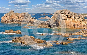 France, Pink Granite Coast. Textured rock formations and crystal clear blue water in Perros-Guirec, Brittany, France.
