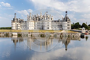 France. Royal Castle of Chambord and its reflection in the water of the river